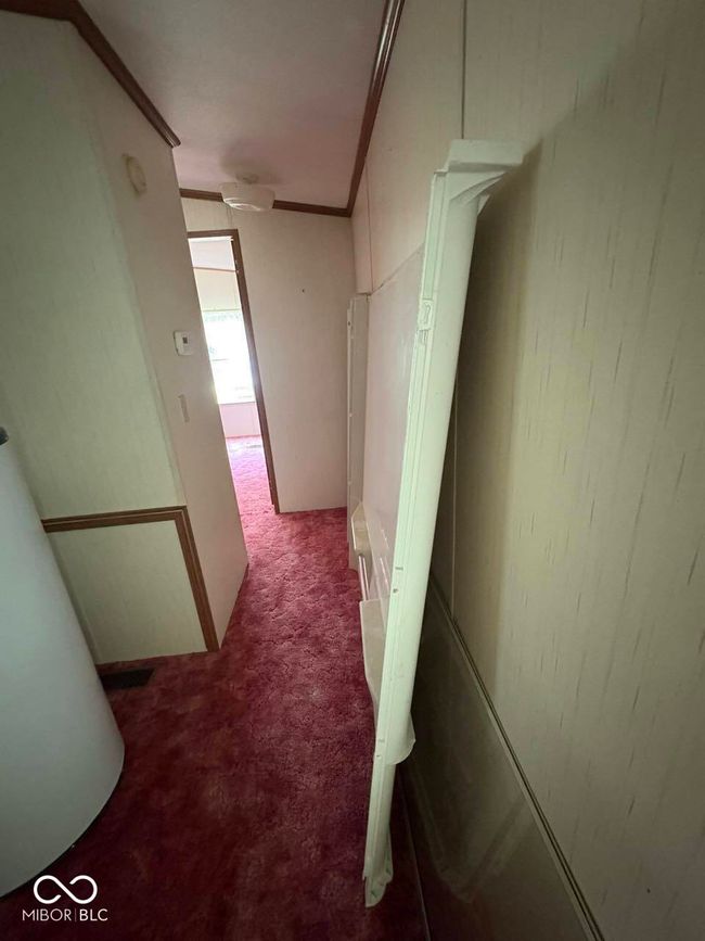 corridor with carpet and crown molding | Image 21