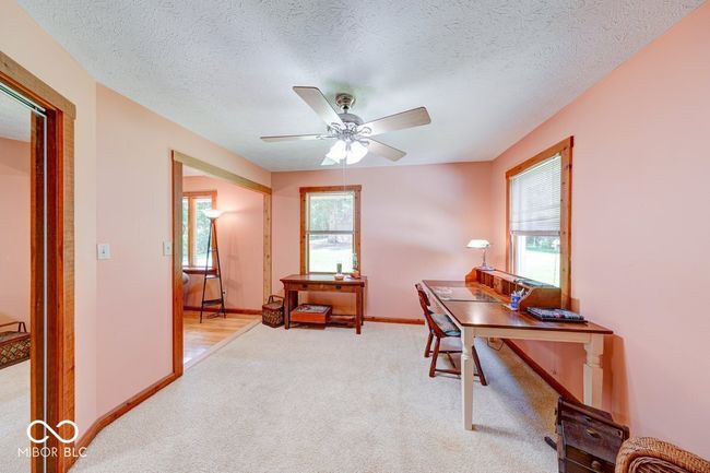 office area featuring light colored carpet, a ceiling fan, and a textured ceiling | Image 30