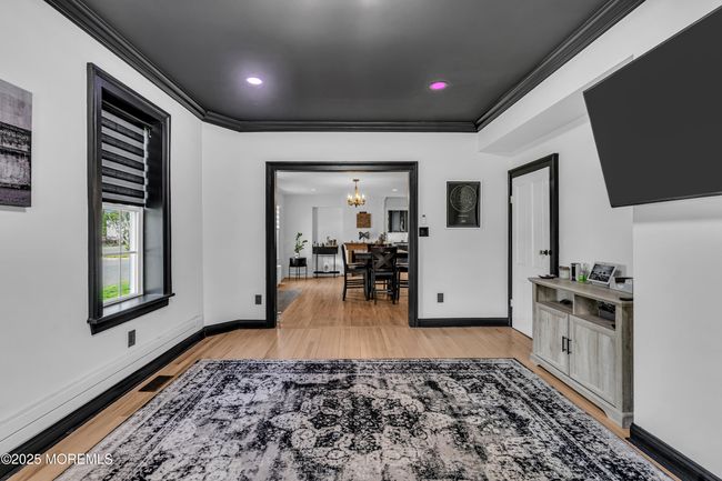 Living room with doorway to pantry , basement and another access to yard. | Image 12