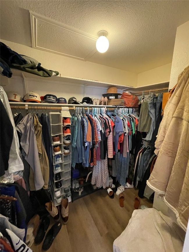 Walk in closet featuring wood finished floors | Image 6