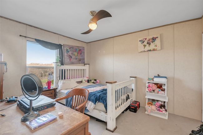 Bedroom featuring concrete floors and a ceiling fan | Image 28
