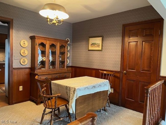 Dining space featuring closet storage & chandelier | Image 15
