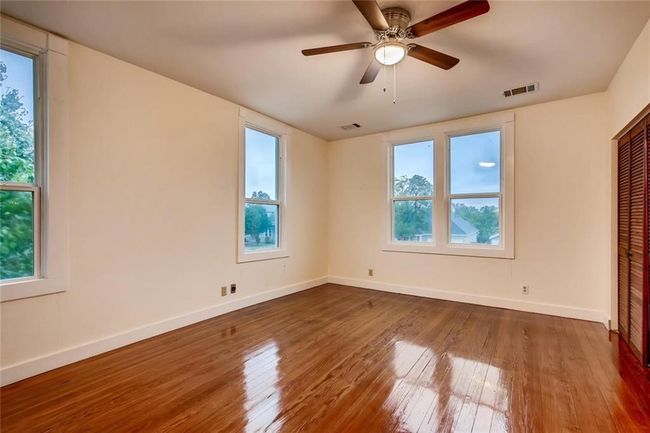 Empty room with baseboards, hardwood / wood-style floors, and ceiling fan | Image 14
