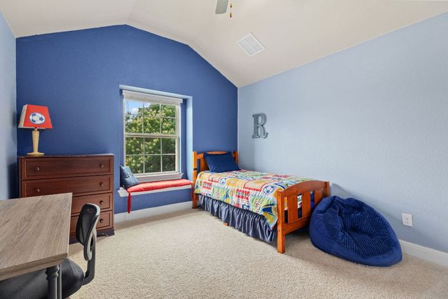 Carpeted bedroom with vaulted ceiling, ceiling fan, and baseboards | Image 28