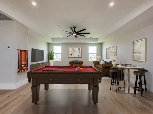 Virtual Staged Large upstairs game room with recessed lighting, ceiling fan, light wood-style flooring, and a raised ceiling | Image 40