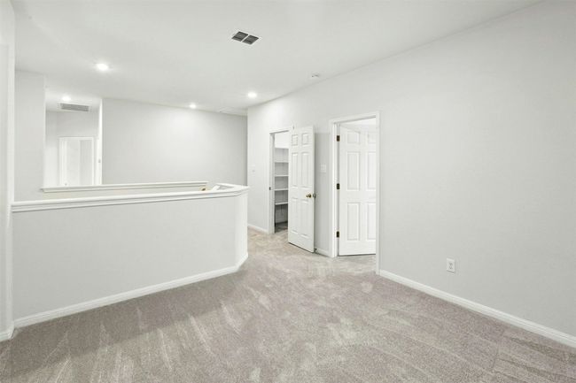 Upstairs, there's a second living area that's perfect for multi-generational households. It's a versatile space that can easily be turned into a game or media room. | Image 13
