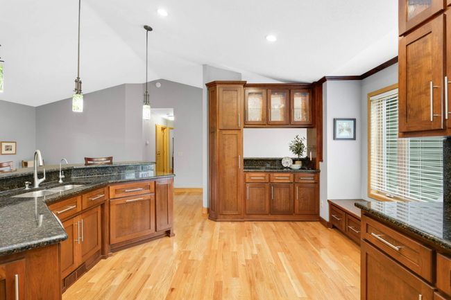 Charming pendant lights adorn the kitchen island. | Image 10