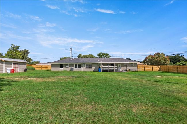 Rear view of house featuring a fenced backyard and an outbuilding | Image 31