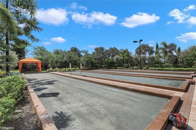 View of property's community featuring a game area, a gazebo, and view of wooded area | Image 36