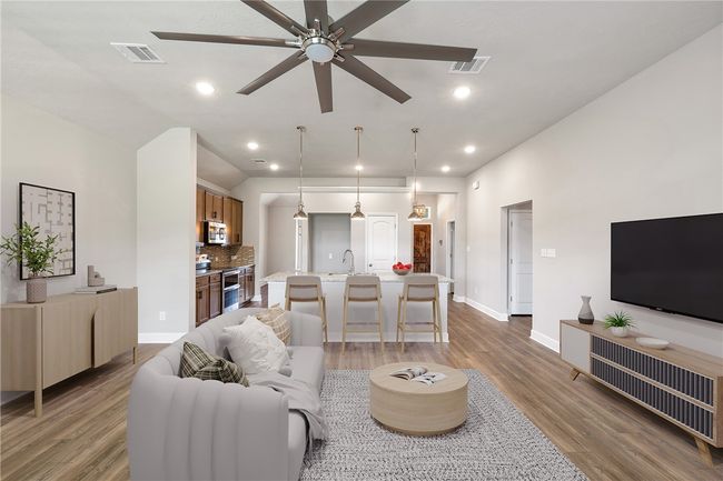 Living room featuring a ceiling fan, wood finished floors, baseboards, and recessed lighting | Image 13