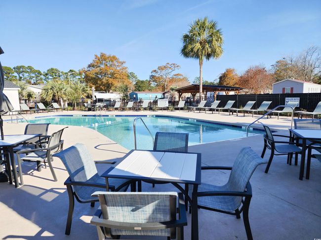 View of swimming pool with a patio | Image 36
