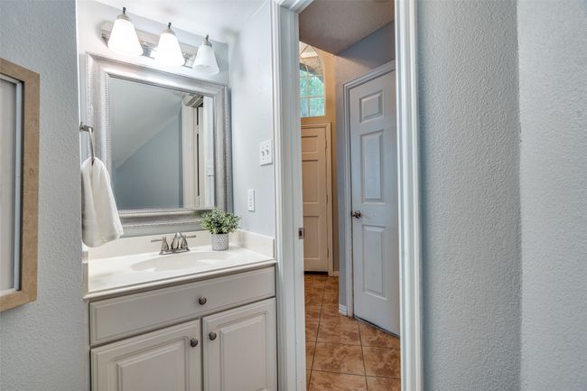 Bathroom featuring vanity, tile patterned floors, and a textured wall | Image 12