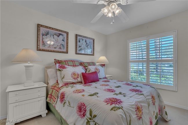 Bedroom with light colored carpet, baseboards, and a ceiling fan | Image 20