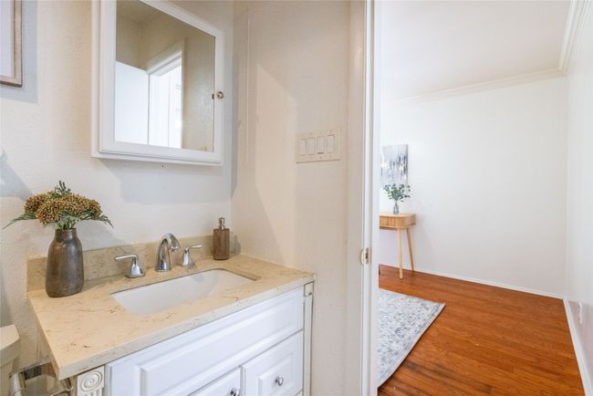 Bathroom with vanity, wood finished floors, and ornamental molding | Image 11