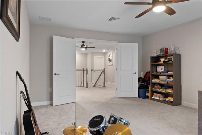Exercise area featuring carpet, ceiling fan, and visible vents | Image 31