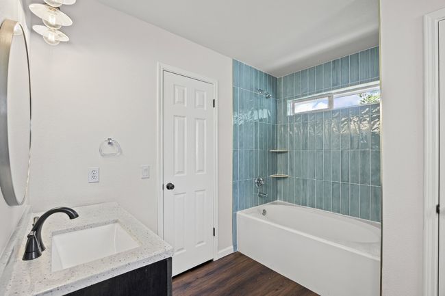Full bathroom with shower combination, vanity, and wood finished floors | Image 18