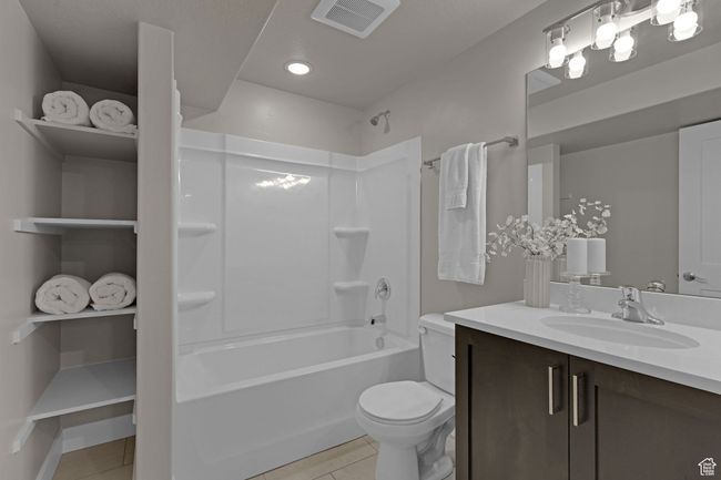 Full bathroom with tile patterned floors, vanity, shower / washtub combination, and recessed lighting | Image 17