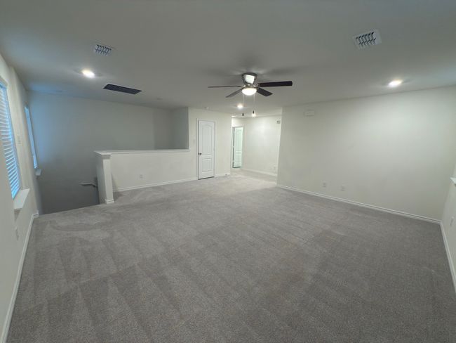 Empty room with carpet flooring, recessed lighting, ceiling fan, and baseboards | Image 34
