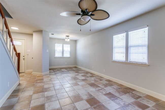 Unfurnished room with a ceiling fan and stairway | Image 5