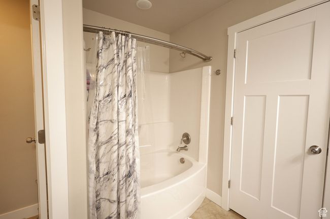 Full bath with shower / bath combo with shower curtain and light tile patterned flooring | Image 7