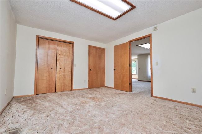 Unfurnished bedroom featuring two closets and light colored carpet | Image 30