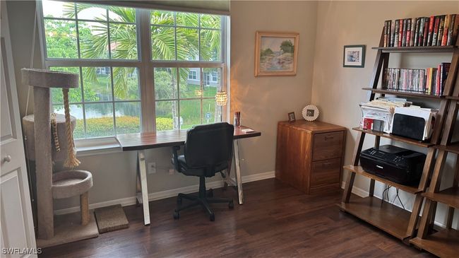 Office space with dark wood-style flooring and baseboards | Image 9