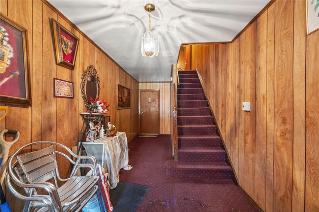 Stairway featuring wooden walls and carpet | Image 22
