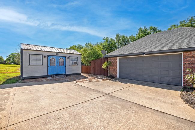 Garage featuring driveway and fence | Image 29