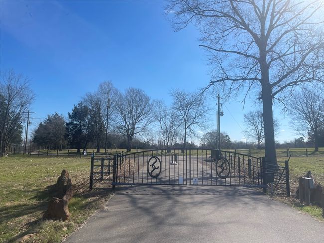 View of gate featuring fence and a yard | Image 6