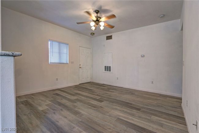 Spare room featuring wood finished floors, a ceiling fan, and baseboards | Image 5