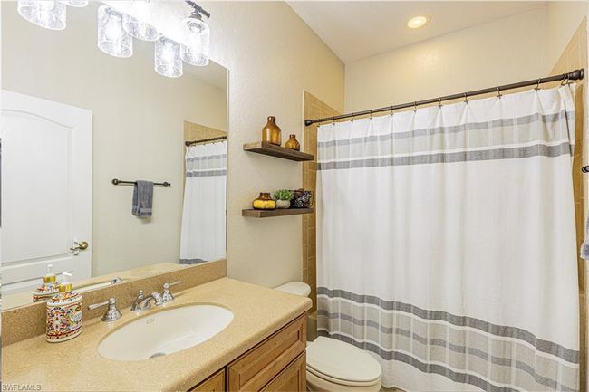 Full bath with curtained shower, toilet, and vanity | Image 15