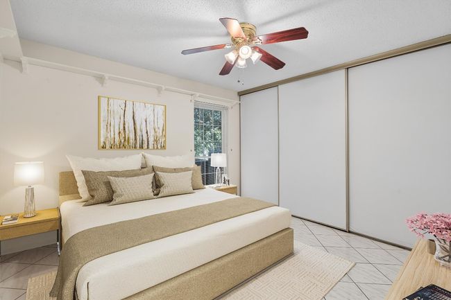 Bedroom with a closet, light tile patterned floors, and ceiling fan | Image 24