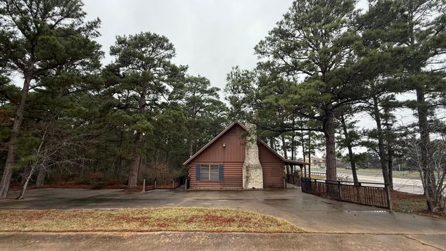 View of side of property with fence, driveway, and log siding | Image 21