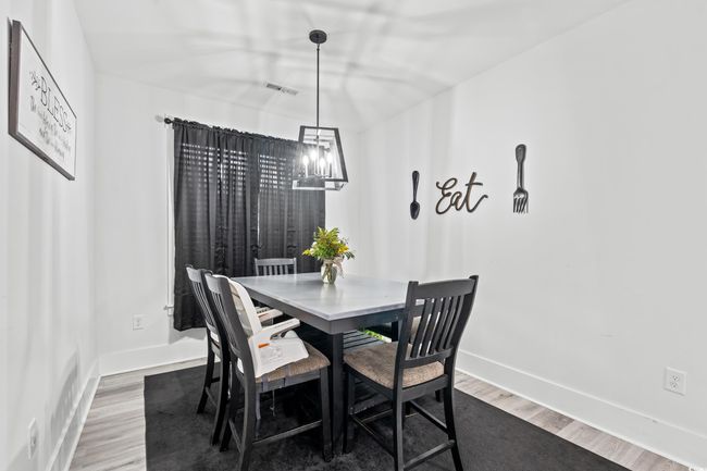 Dining room featuring wood finished floors and a chandelier | Image 15