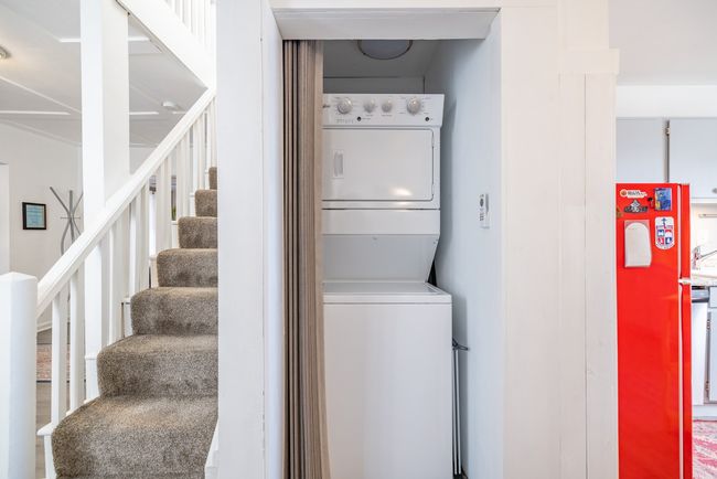 Laundry area featuring stacked washer / drying machine | Image 24