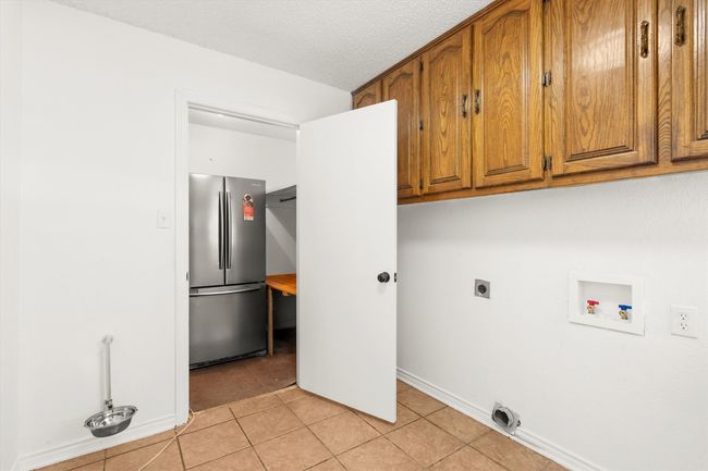 Laundry room with extra freezer/refrigerator closet | Image 13