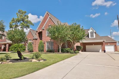 Abundant parking with a spacious three-car garage and additional carport. | Image 3