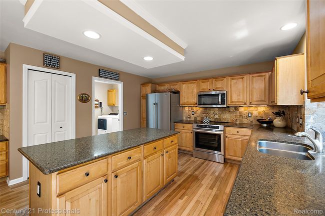 Newly finished wood flooring throughout kitchen | Image 19