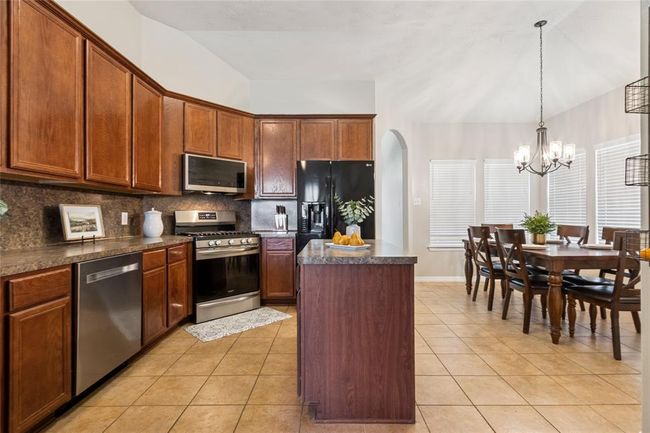 The kitchen offers plenty of cabinets and countertop space. New dishwasher in May 2025. | Image 12