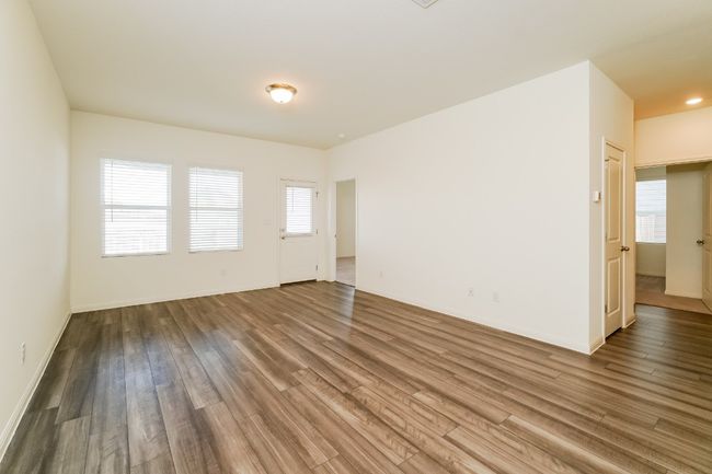 Spare room featuring wood finished floors and baseboards | Image 5