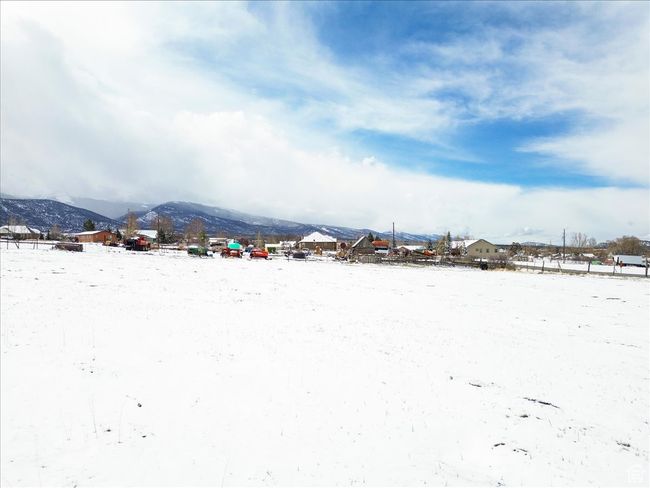 Snowy yard featuring a mountain view | Image 13