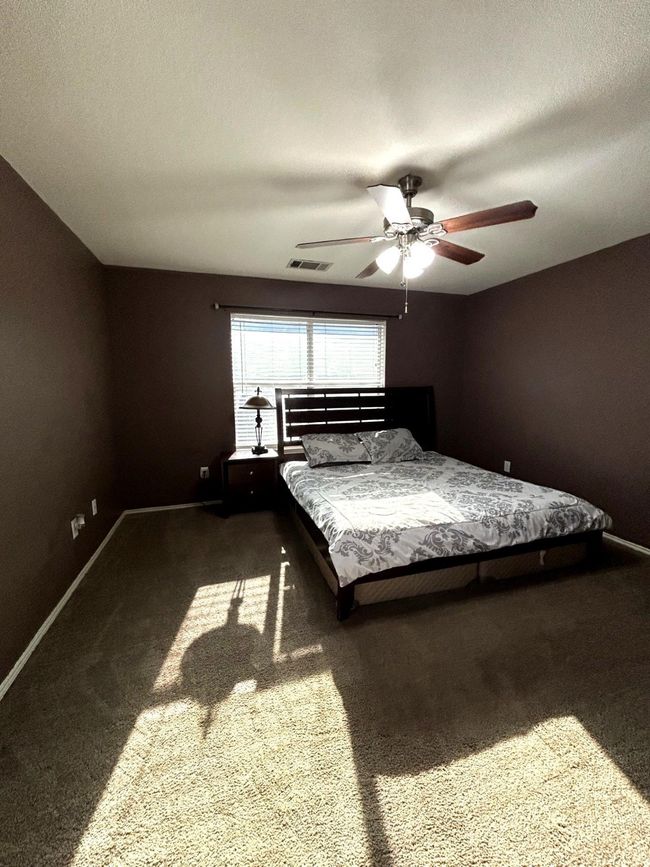 Carpeted bedroom with baseboards and a ceiling fan | Image 8