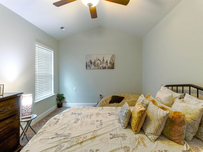 Bedroom featuring ceiling fan and lofted ceiling | Image 26