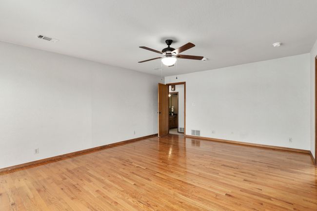 Spare room featuring visible vents, ceiling fan, baseboards, and light wood-style floors | Image 22