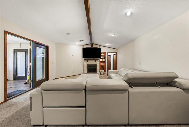 Living room featuring a fireplace and carpet floors | Image 19