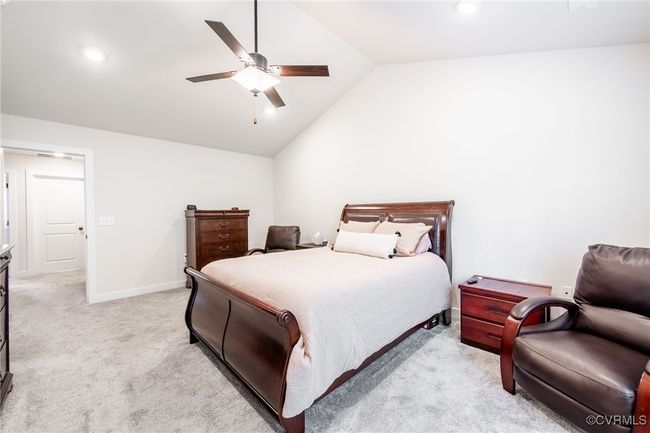 Primary Bedroom featuring lofted ceiling, light colored carpet, ceiling fan, and recessed lighting | Image 17
