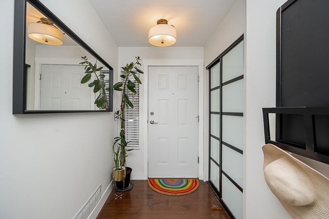 Doorway with wood finished floors, baseboards, and visible vents | Image 28