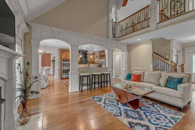 This view shows the grace of the arch entries, the family room, the breakfast bar, and the catwalk. | Image 14