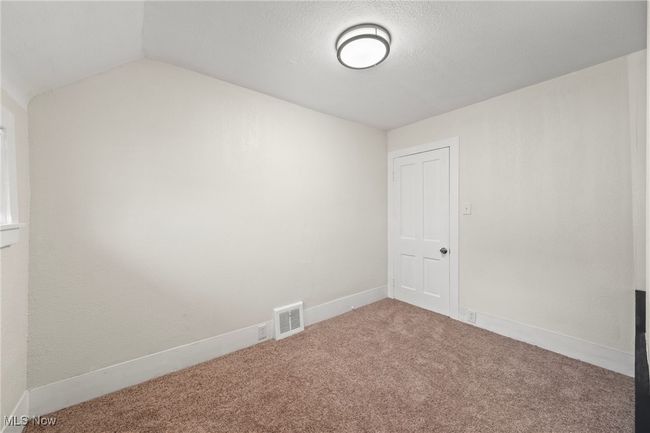 Carpeted empty room with vaulted ceiling | Image 24