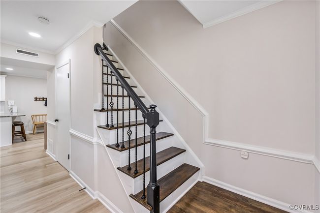 Staircase with ornamental molding, and wood finished floors | Image 12
